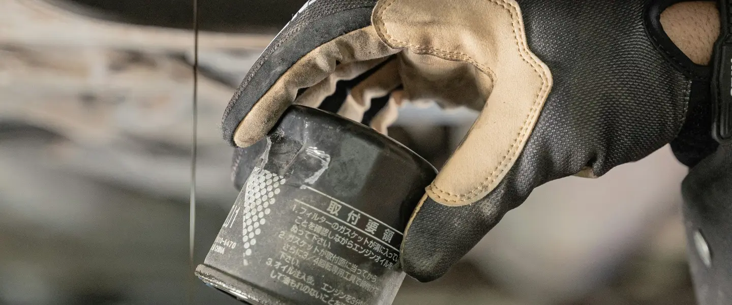 Mecánico vertiendo aceite nuevo en el motor de un coche